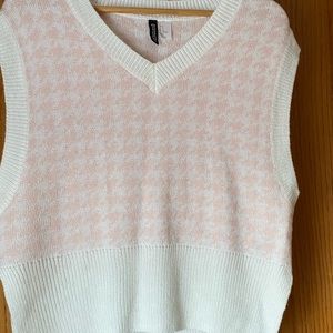 Pink and white sweater vest.